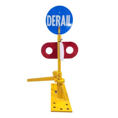 A blue circular sign reading "DERAIL" on a yellow post with a red, two-sided target and an operating lever.