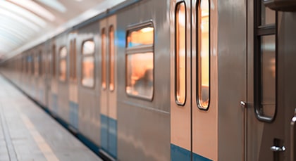A commuter train car stopped at a train station